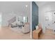 Bright, open-concept living room with neutral decor, stairs, and adjacent foyer area at 5049 Lundy Dr # 102, Raleigh, NC 27606