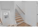 Bright staircase with light wood treads, white risers, and a minimalist handrail design at 5049 Lundy Dr # 102, Raleigh, NC 27606