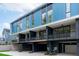 Modern townhome exterior with striking blue accents, large windows, and private balconies at 511 S Bloodworth St # 102, Raleigh, NC 27601