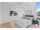 Bright main bedroom with hardwood floors, tall windows, and modern decor, offers a serene living space at 511 S Bloodworth St # 102, Raleigh, NC 27601