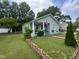 Quaint home featuring a well-manicured lawn and a charming front porch with ample greenery at 514 E Lee St, Smithfield, NC 27577