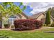 Attractive clubhouse with stone and siding, manicured lawn, and appealing landscaping under a partly cloudy sky at 5144 Niagra Dr, Chapel Hill, NC 27517