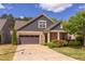 Charming home exterior with stone and siding, featuring a well-maintained lawn and mature landscaping at 5144 Niagra Dr, Chapel Hill, NC 27517