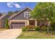 Charming home exterior with stone and siding, featuring a well-maintained lawn and mature landscaping at 5144 Niagra Dr, Chapel Hill, NC 27517