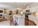 Open kitchen and living room layout with granite counters, stainless appliances, and hardwood flooring at 5144 Niagra Dr, Chapel Hill, NC 27517