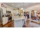 Bright kitchen with stainless steel appliances, granite counters, an island and hardwood floors at 5144 Niagra Dr, Chapel Hill, NC 27517