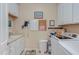 Functional laundry room with white cabinets, a sink, and a washer and dryer at 5144 Niagra Dr, Chapel Hill, NC 27517