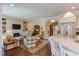 Open floor plan with an eat-in kitchen that flows into the living room featuring hardwood floors and fireplace at 5144 Niagra Dr, Chapel Hill, NC 27517