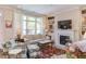 Bright living room with built-in bookshelves, fireplace, and a large window at 5144 Niagra Dr, Chapel Hill, NC 27517