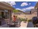 Inviting outdoor patio with a metal table set for al fresco dining and a lush garden at 5144 Niagra Dr, Chapel Hill, NC 27517