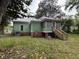 Back exterior with a screened porch and wooden stairs leading to the yard at 515 E Woodall St, Smithfield, NC 27577