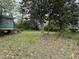 Spacious backyard surrounded by mature trees offering a serene outdoor space at 515 E Woodall St, Smithfield, NC 27577
