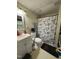 Functional bathroom featuring a vanity with sink and shower with floral shower curtain at 515 E Woodall St, Smithfield, NC 27577