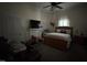 Cozy bedroom featuring a window with curtains, a fireplace and a ceiling fan at 515 E Woodall St, Smithfield, NC 27577