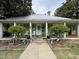 Charming single story home featuring a porch with columns and a metal roof at 515 E Woodall St, Smithfield, NC 27577