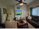 Cozy living room showcasing a comfortable leather sofa, television and natural light at 515 E Woodall St, Smithfield, NC 27577