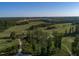 A scenic aerial view captures the serene golf course, nature trails, and surrounding landscape at 525 Morning Oaks Dr, Holly Springs, NC 27540
