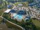 Overhead view of the community clubhouse, featuring a pool, lounge area, and well-maintained grounds at 525 Morning Oaks Dr, Holly Springs, NC 27540