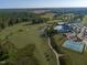 Scenic aerial shot showcasing the golf course's lush greenery, community pool, tennis courts, and natural beauty at 525 Morning Oaks Dr, Holly Springs, NC 27540