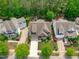 Beautiful aerial view showcases the home's meticulous landscaping, well-kept lawn, and inviting curb appeal at 525 Morning Oaks Dr, Holly Springs, NC 27540