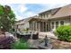 Landscaped backyard with brick patio, screened porch, and comfortable seating arrangement at 525 Morning Oaks Dr, Holly Springs, NC 27540