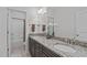 Elegant bathroom with granite counters, double sinks, and a shower at 525 Morning Oaks Dr, Holly Springs, NC 27540