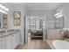 Bathroom featuring a soaking tub with tile surround, granite counters, and doorway view to the main bedroom at 525 Morning Oaks Dr, Holly Springs, NC 27540