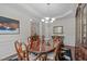 Formal dining room featuring a wood table, decorative rug, and elegant chandelier at 525 Morning Oaks Dr, Holly Springs, NC 27540