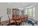 Spacious dining room with large windows and a classic china cabinet at 525 Morning Oaks Dr, Holly Springs, NC 27540