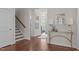 Bright foyer boasts hardwood floors, a staircase, and elegant decor at 525 Morning Oaks Dr, Holly Springs, NC 27540