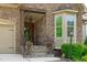 Close up of charming stone home featuring a covered front porch, steps, and bay window at 525 Morning Oaks Dr, Holly Springs, NC 27540