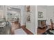 Inviting hallway with hardwood floors leads to a spacious living room with elegant decor and plenty of natural light at 525 Morning Oaks Dr, Holly Springs, NC 27540