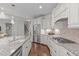 Bright kitchen featuring white cabinets, stainless steel appliances, granite counters, and a large center island at 525 Morning Oaks Dr, Holly Springs, NC 27540