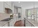 Gourmet kitchen with white cabinets, granite countertops, stainless steel appliances and a gas cooktop at 525 Morning Oaks Dr, Holly Springs, NC 27540