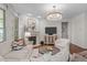 Cozy living room features a fireplace, plush seating, chandelier and a large window with plenty of natural light at 525 Morning Oaks Dr, Holly Springs, NC 27540