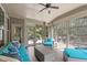 Comfortable sunroom featuring a ceiling fan, neutral tones, and screened windows for seamless indoor-outdoor living at 525 Morning Oaks Dr, Holly Springs, NC 27540