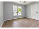Bedroom with LVP flooring and large window at 5317 Cottage Bluff Ln, Knightdale, NC 27545