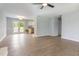 Open-concept living room with wood-look floors flowing into an eat-in kitchen with stainless appliances at 5317 Cottage Bluff Ln, Knightdale, NC 27545