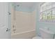 Bathroom featuring a tiled shower and a window at 5705 Tannibark Ln, Fuquay Varina, NC 27526