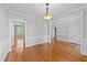 Spacious dining area with hardwood floors, wainscoting, and elegant chandelier at 5705 Tannibark Ln, Fuquay Varina, NC 27526