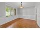 Elegant dining room featuring hardwood floors, wainscoting, and abundant natural light at 5705 Tannibark Ln, Fuquay Varina, NC 27526