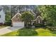 Beautiful two story brick home with mature landscaping, two car garage, and covered entry at 5705 Tannibark Ln, Fuquay Varina, NC 27526