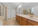 Luxurious main bathroom with a dual sink vanity, walk-in shower and ceramic tile floors at 5705 Tannibark Ln, Fuquay Varina, NC 27526
