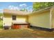 Rear exterior of home with basement entrance and AC unit at 5743 Craig Rd, Durham, NC 27712