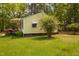 Home's exterior with awning over window, and landscaped yard at 5743 Craig Rd, Durham, NC 27712