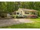 Quaint home featuring a carport, outbuilding, and lovely landscaping at 5743 Craig Rd, Durham, NC 27712