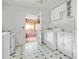 White kitchen offers vintage charm with classic tile, appliances, and an adjacent utility area at 5743 Craig Rd, Durham, NC 27712