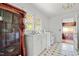 Classic white kitchen with vintage tiling, ample natural light, and views of the utility area at 5743 Craig Rd, Durham, NC 27712
