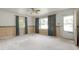 Bright living room featuring vintage wallpaper, large windows, and a ceiling fan at 5743 Craig Rd, Durham, NC 27712