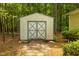 A storage shed on a level lot surrounded by mature trees at 5743 Craig Rd, Durham, NC 27712